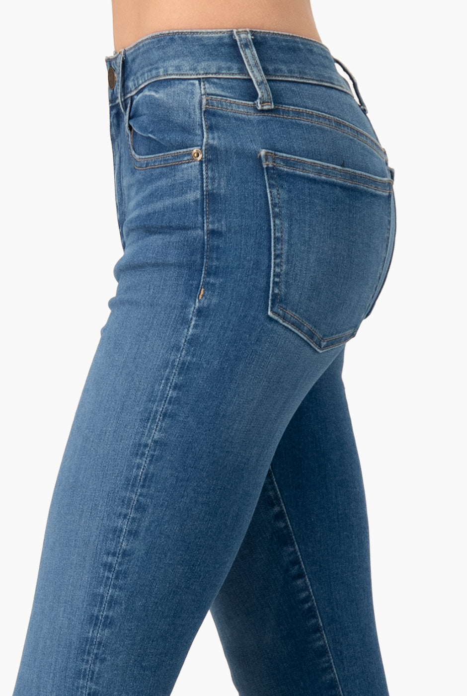 Jeans skinny azul con detalle deshilachado y bolsillos traseros.