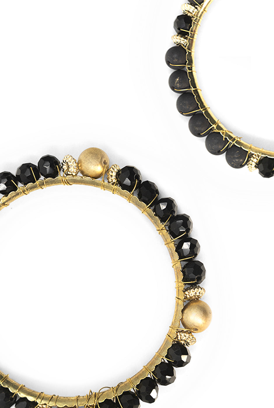 Set de tres pulseras negras y doradas con diseño en espiral.